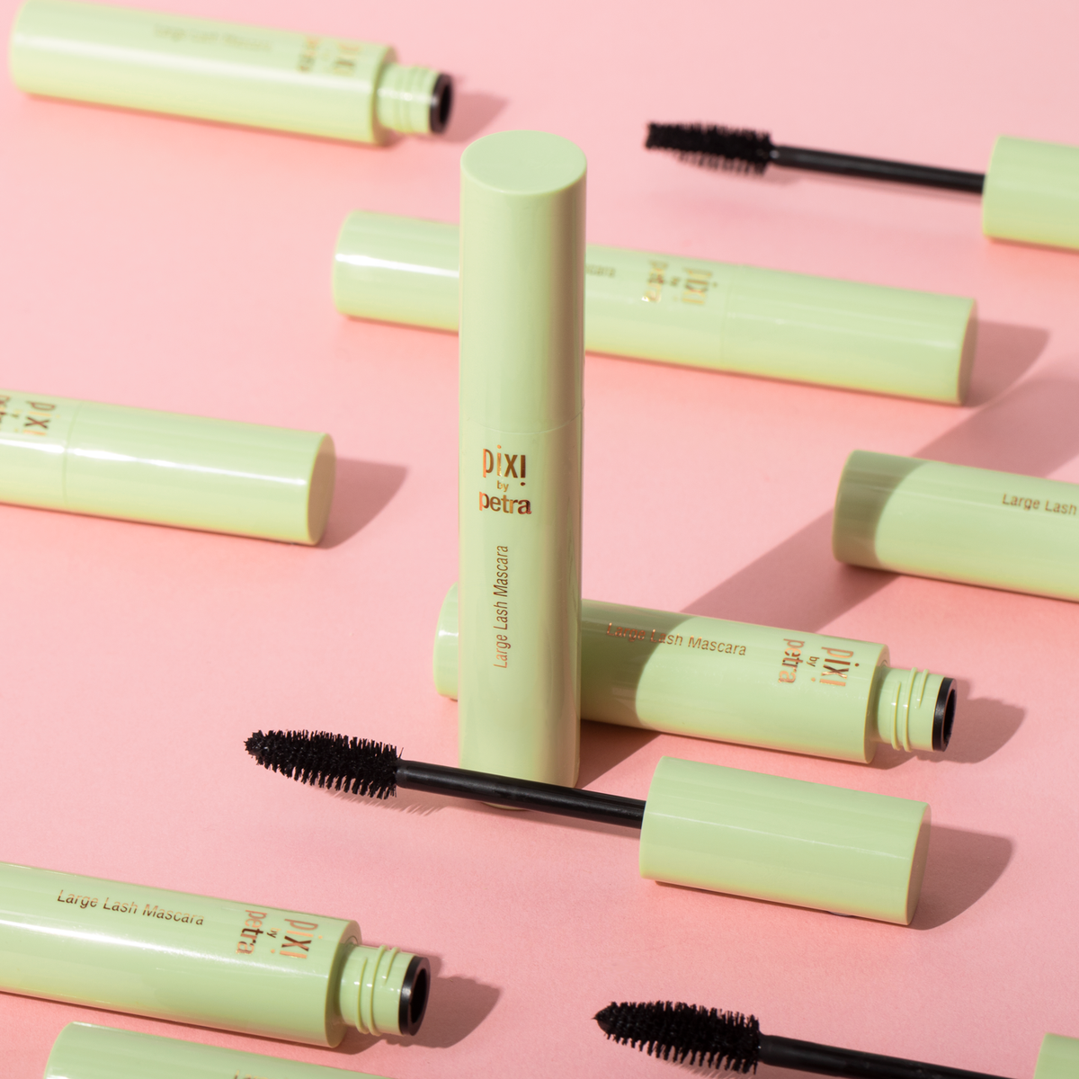 Large Lash Mascara in multiple bottles on a pink background