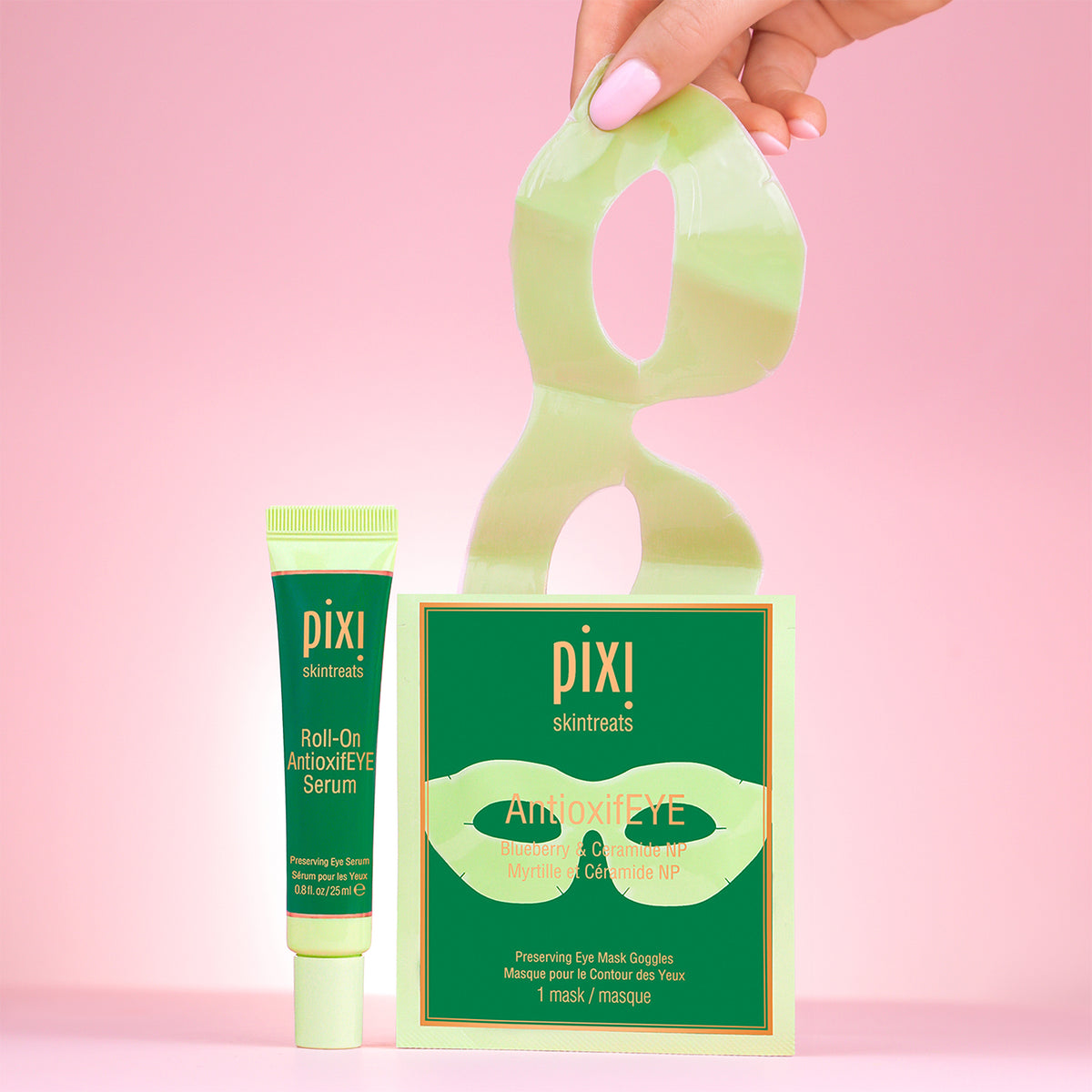 PIXI skincare products including AntioxifEYE Eye Mask Goggles and Roll-on AntioxifEYE serum on a pink background with hand reaching