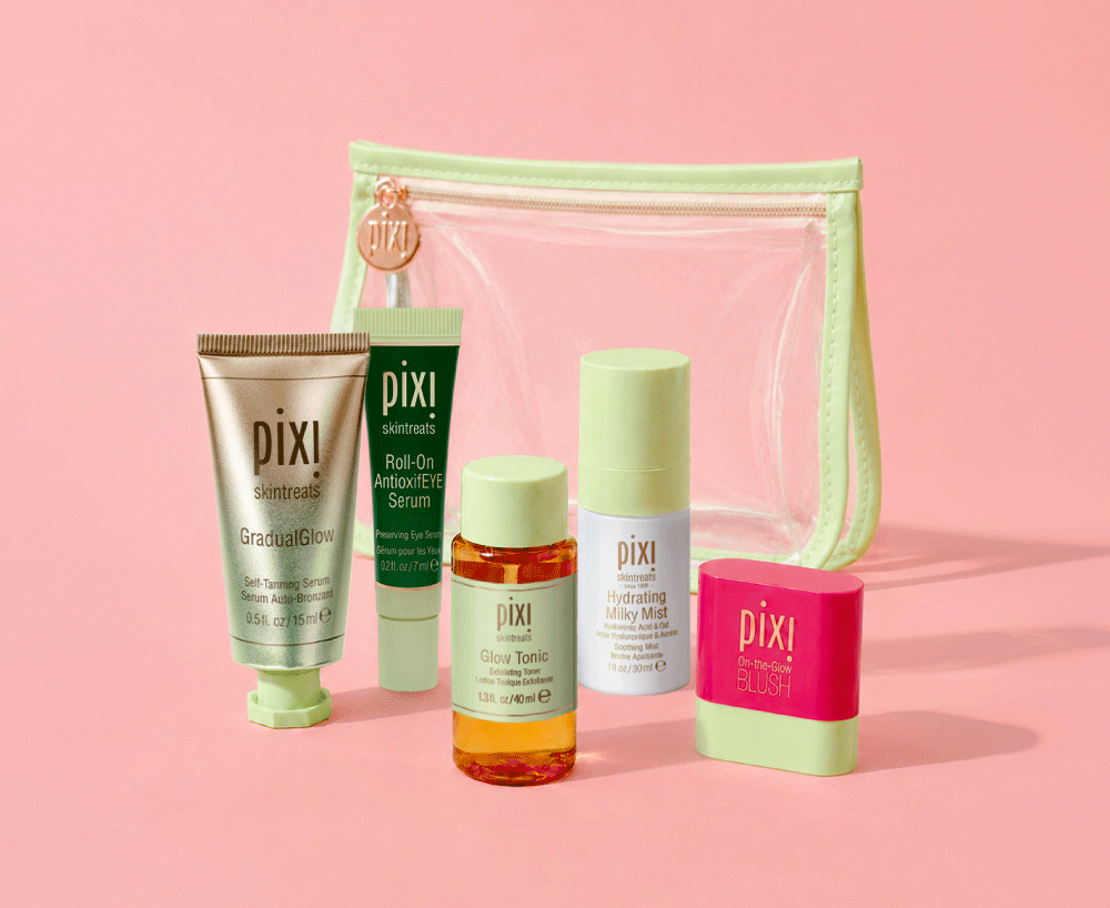 GradualGlow, Roll-On AntioxifEYE Serum, Glow Tonic, Hydrating Milky Mist and On-the-Glow Blush in petite sizes shown on a pink background with Clear Travel Bag - View 2