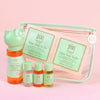 Pixi skincare products including bottles and a pouch on a pink background