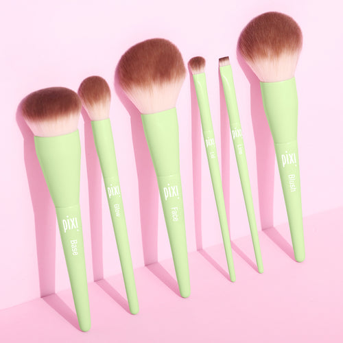 Set of Pixi makeup brushes with green handles on a pink background view 1