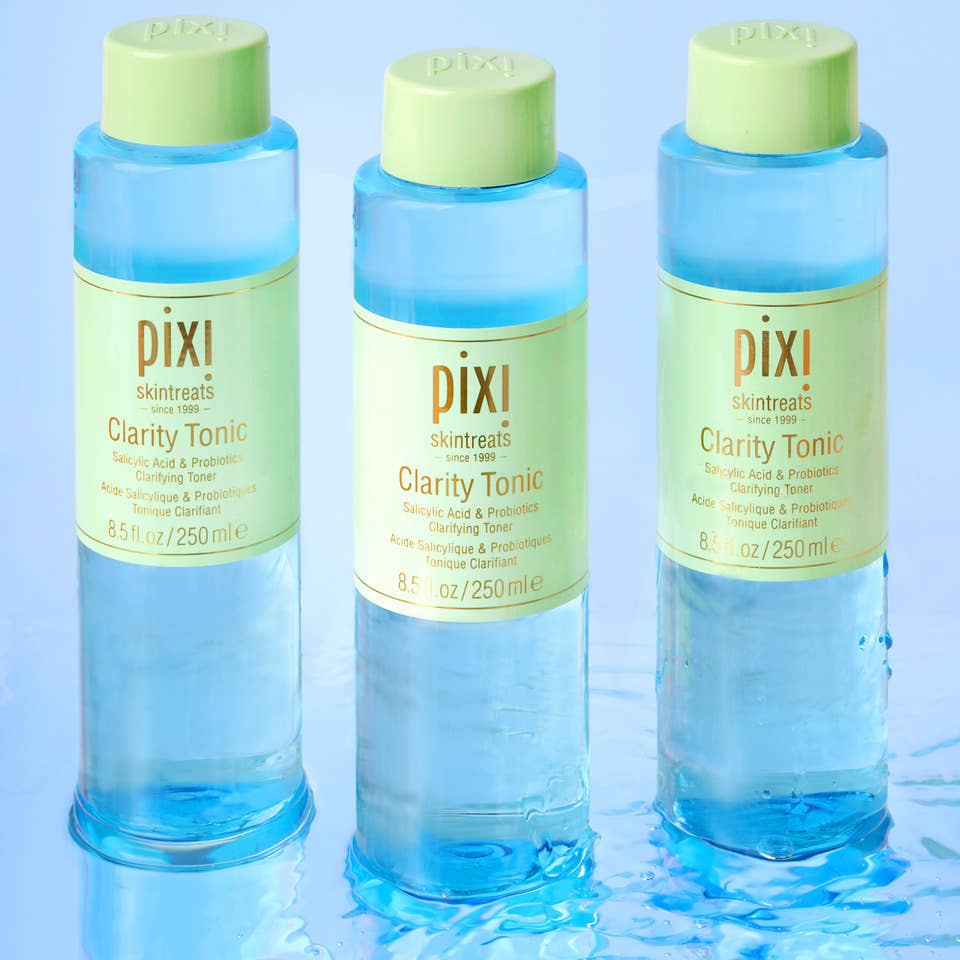 Three bottles of Pixi Clarity Tonic on a light blue background view 1