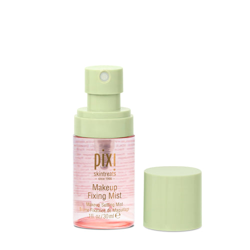 Pixi Skintreats Makeup Fixing Mist in a clear bottle with a pale green spray pump, shown next to its matching light green cap on a white background. view 1